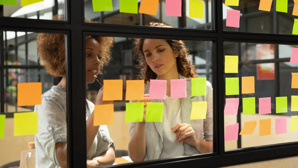 Two women working together in the office to create their desired future.